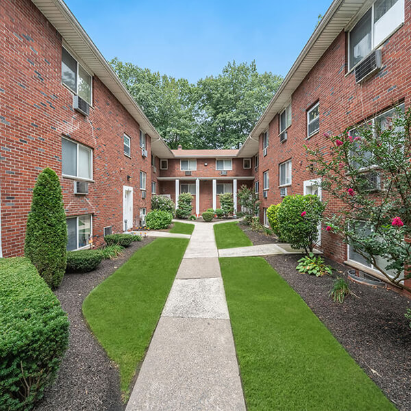 grassy walkway between apartment buildings